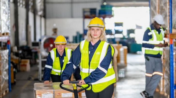 Warehouse workers with uniform working in distribution warehouse.