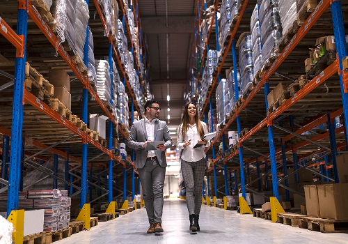 warehouse-managers-walking-through-large-distribution-center