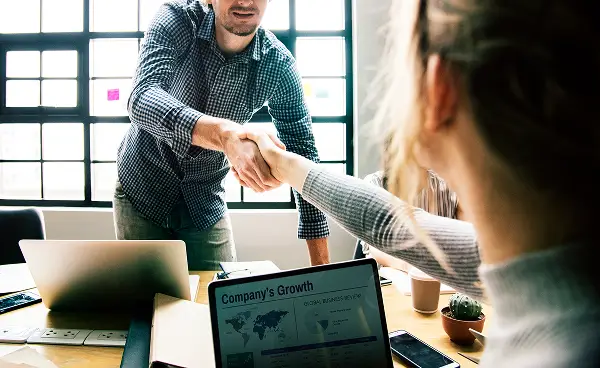 Business partners shaking hands on a B2B agreement