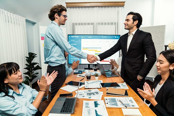 Business team celebrating a successful project in a meeting room