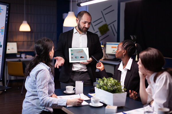 Sales representative presenting sales data on a tablet